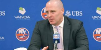 New York Islanders GM Mathieu Darche speaking at a press conference with a news graphic banner overlay at the bottom reading "2026 first-round picks available for trade."