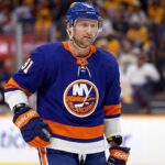 A visualization of Nashville Predators forward Steven Stamkos wearing a New York Islanders home jersey with the number 91, standing on the ice during a game.