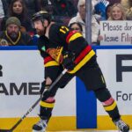 Vancouver Canucks defenseman Filip Hronek skating during an NHL game. Hronek is currently the subject of intense trade rumors which his agent, Allan Walsh, has publicly denied.