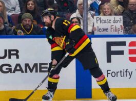 Vancouver Canucks defenseman Filip Hronek skating during an NHL game. Hronek is currently the subject of intense trade rumors which his agent, Allan Walsh, has publicly denied.
