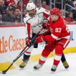Can the Caps Bounce Back in Hockeytown? Capitals vs Red Wings Viewing Guide & Picks Washington Capitals' Alex Ovechkin (8) and Detroit Red Wings' Alex DeBrincat (93) battle for possession of the puck along the boards with their sticks engaged during an NHL game at Little Caesars Arena.