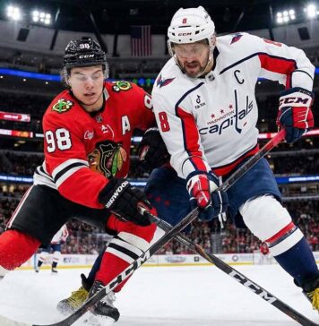 Can the Blackhawks Stay Hot vs. Ovechkin’s Capitals? Watch Live Tonight Chicago Blackhawks center Connor Bedard (#98) and Washington Capitals captain Alex Ovechkin (#8) battle fiercely for puck possession with their sticks on the ice during an NHL game at the United Center.