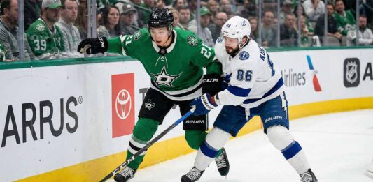 Dallas Stars' Jason Robertson and Tampa Bay Lightning's Nikita Kucherov battle for the puck along the boards during a 2026 NHL regular season game.