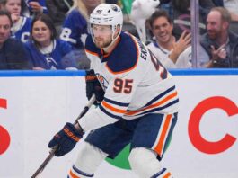 A concept visualization showing current Toronto Maple Leafs defenseman Oliver Ekman-Larsson (95) wearing a white Edmonton Oilers away jersey, helmet, and gloves, skating with the puck during a game environment.