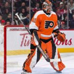 Toronto Maple Leafs goaltender Anthony Stolarz, wearing number 41 white jersey and matching blue and white gear, stands in the crease in front of his net during an NHL game.
