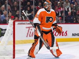 Toronto Maple Leafs goaltender Anthony Stolarz, wearing number 41 white jersey and matching blue and white gear, stands in the crease in front of his net during an NHL game.