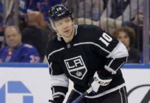 Los Angeles Kings forward Artemi Panarin, wearing a black jersey with the number 10, looks to his left while on the ice during a game.