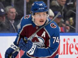 Why Bobby McMann is the Colorado Avalanche’s Secret Trade Weapon Colorado Avalanche forward Bobby McMann (74) looking up on the ice, wearing the team's maroon home jersey and a blue helmet during a game.