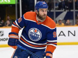 Edmonton Oilers center Ryan O'Reilly (90) skating on the ice in a royal blue home jersey during an NHL game.