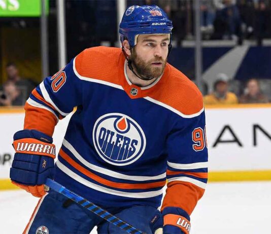 Edmonton Oilers center Ryan O'Reilly (90) skating on the ice in a royal blue home jersey during an NHL game.