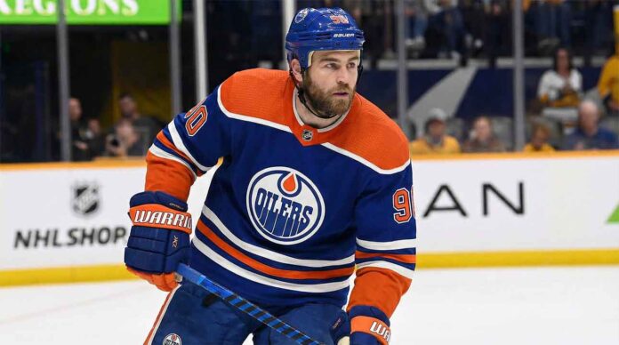 edmonton-oilers-ryan-oreilly-trade-rumor Edmonton Oilers center Ryan O'Reilly (90) skating on the ice in a royal blue home jersey during an NHL game.