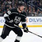 Elias Pettersson, wearing a black Los Angeles Kings #40 jersey and helmet, stands on the ice holding his hockey stick during a game.