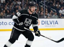 Elias Pettersson, wearing a black Los Angeles Kings #40 jersey and helmet, stands on the ice holding his hockey stick during a game.