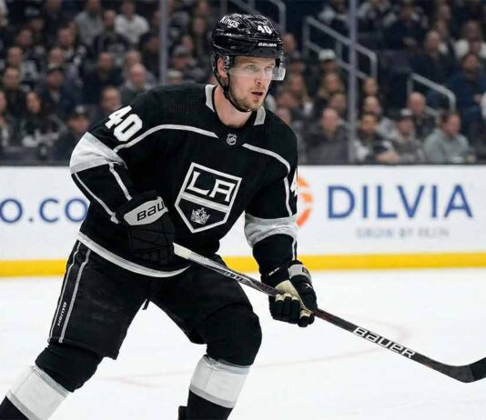 Elias Pettersson, wearing a black Los Angeles Kings #40 jersey and helmet, stands on the ice holding his hockey stick during a game.