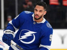 Tampa Bay Lightning Linked to Evander Kane: A Genius Move? Evander Kane wearing a blue Tampa Bay Lightning home uniform, number 9, skating on the ice and holding his hockey stick during a game.