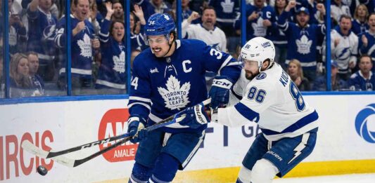 Will the Maple Leafs Upset the Lightning? How to Watch & Odds! Toronto Maple Leafs captain Auston Matthews battles for possession of the puck against Tampa Bay Lightning forward Nikita Kucherov along the boards during an NHL game at Amalie Arena.