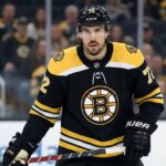 Defenseman Justin Faulk pictured on the ice wearing a black Boston Bruins home jersey with the number 72, holding his hockey stick during a game setting.