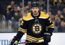 Defenseman Justin Faulk pictured on the ice wearing a black Boston Bruins home jersey with the number 72, holding his hockey stick during a game setting.