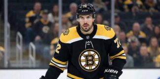 Defenseman Justin Faulk pictured on the ice wearing a black Boston Bruins home jersey with the number 72, holding his hockey stick during a game setting.