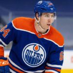 Why the Edmonton Oilers Are Pivoting to Winnipeg Jets’ Logan Stanley Edmonton Oilers defenseman Logan Stanley, wearing number 64 in a blue home jersey, looking to his left while on the ice during a game.