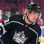A mock-up illustration showing current Montreal Canadiens forward Patrik Laine wearing a black number 92 Los Angeles Kings jersey and helmet, holding his hockey stick on the ice.