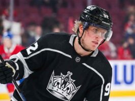 A mock-up illustration showing current Montreal Canadiens forward Patrik Laine wearing a black number 92 Los Angeles Kings jersey and helmet, holding his hockey stick on the ice.