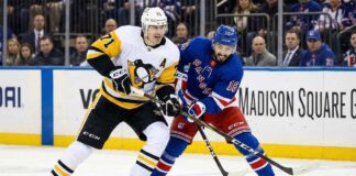 Pittsburgh Penguins center Evgeni Malkin (#71) and New York Rangers center Vincent Trocheck (#16) battle for a loose puck during an NHL game at Madison Square Garden.