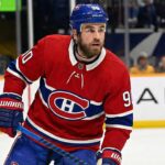 Why the Montreal Canadiens’ Secret Push for Ryan O’Reilly Makes Perfect Sense A concept visualization showing current Nashville Predators center Ryan O'Reilly wearing a Montreal Canadiens red home uniform and blue helmet on the ice, illustrating recent NHL trade rumors linking the veteran forward to the Habs.