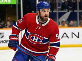 Why the Montreal Canadiens’ Secret Push for Ryan O’Reilly Makes Perfect Sense A concept visualization showing current Nashville Predators center Ryan O'Reilly wearing a Montreal Canadiens red home uniform and blue helmet on the ice, illustrating recent NHL trade rumors linking the veteran forward to the Habs.