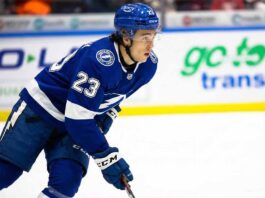 Tampa Bay Lightning prospect Sam O'Reilly, wearing a blue number 23 jersey and helmet, skating on the ice during game action.