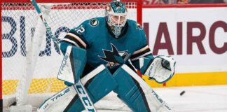 Sergei Bobrovsky pictured in a full teal and black San Jose Sharks goaltending uniform, positioned in a butterfly stance on the ice in front of the net.