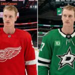 The Untold Reason Tyler Myers Hasn’t Waived His NMC Yet A vertically split image. The left panel shows professional hockey player Tyler Myers in a red Detroit Red Wings home jersey, with an alternate captain's "A" on his shoulder and a red and white glove in hand, standing in Little Caesars Arena. The right panel shows Tyler Myers in a Victory Green Dallas Stars home jersey, also with an alternate captain's "A" and a black and green glove, standing in American Airlines Center.