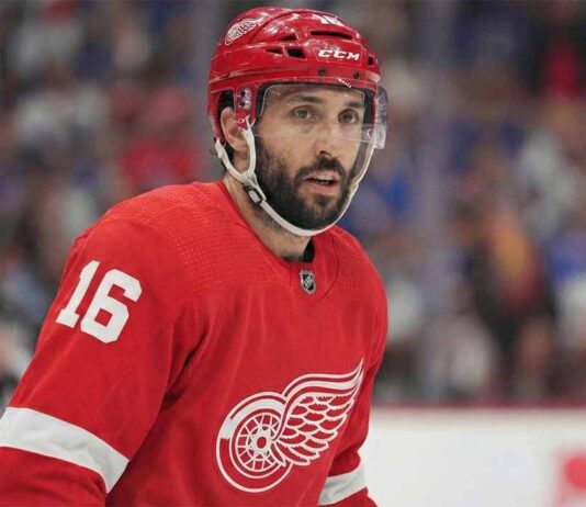 NHL center Vincent Trocheck depicted wearing a Detroit Red Wings home jersey with the number 16 and a corresponding red helmet while on the ice during a game.