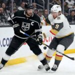 Los Angeles Kings captain Anze Kopitar (left) and Vegas Golden Knights forward Jack Eichel (right) battle fiercely for puck possession along the boards at Crypto.com Arena during an NHL game.