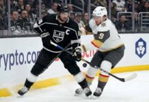 Los Angeles Kings captain Anze Kopitar (left) and Vegas Golden Knights forward Jack Eichel (right) battle fiercely for puck possession along the boards at Crypto.com Arena during an NHL game.