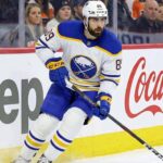 Alex Tuch Contract Extension Update: Buffalo Sabres News Buffalo Sabres winger Alex Tuch (number 89) skating hard along the rink boards featuring Jeep and Coca-Cola advertising during a home game. This image relates to current discussions about Tuch's contract extension and potential free agency.