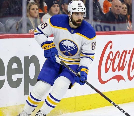 Alex Tuch Contract Extension Update: Buffalo Sabres News Buffalo Sabres winger Alex Tuch (number 89) skating hard along the rink boards featuring Jeep and Coca-Cola advertising during a home game. This image relates to current discussions about Tuch's contract extension and potential free agency.