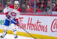 Montreal Canadiens defenseman Arber Xhekaj, wearing jersey #72, skates along the ice during an NHL game. He is looking up while holding his stick.