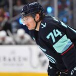 Bobby McMann in a Seattle Kraken jersey getting ready for a faceoff.