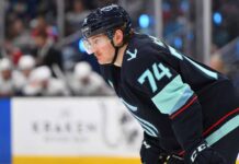 Bobby McMann Trade Rumors: Seattle Kraken & Toronto Maple Leafs News Bobby McMann in a Seattle Kraken jersey getting ready for a faceoff.