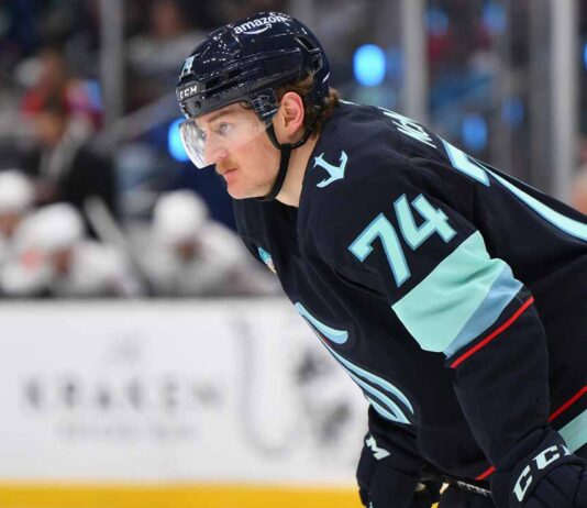 Bobby McMann in a Seattle Kraken jersey getting ready for a faceoff.