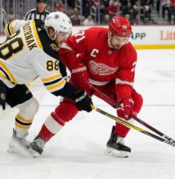 How to Watch Boston Bruins vs Detroit Red Wings | TV Channel & Time Boston Bruins David Pastrnak and Detroit Red Wings Dylan Larkin battle intensely for a puck near the boards at Little Caesars Arena during an Atlantic Division matchup.