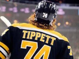 Are the Bruins Mortgaging Their Future for Flyers Star Owen Tippett? A concept image showing Philadelphia Flyers winger Owen Tippett from behind, wearing a black Boston Bruins number 74 jersey, amidst trade rumors linking him to the team.