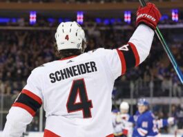 A concept image visualizing current New York Rangers defenseman Braden Schneider wearing a white No. 4 Ottawa Senators jersey and celebrating on the ice amid ongoing NHL trade rumors.
