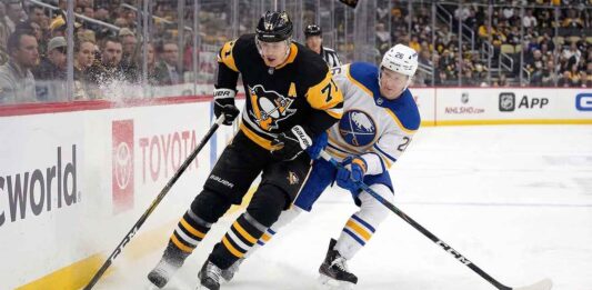 Evgeni Malkin and Rasmus Dahlin battle for the puck during the Buffalo Sabres vs Pittsburgh Penguins NHL game today, March 5, 2026.