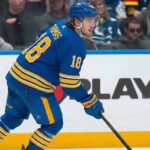 Massive Buffalo Sabres Trade Rumor: Could Robert Thomas Be the Missing Piece? A visualization of St. Louis Blues forward Robert Thomas wearing a blue Buffalo Sabres home jersey and helmet amidst massive NHL trade rumors connecting the two teams.