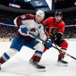 What Channel is the Calgary Flames vs Colorado Avalanche Game On Tonight? | TV & Stream Guide An action photograph capturing Colorado Avalanche forward Nathan MacKinnon and Calgary Flames forward Mikael Backlund in an intense stick battle for the puck on the ice at Ball Arena in Denver during a regular season NHL game.