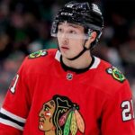 A close-up photograph of hockey player Jason Robertson wearing a red Chicago Blackhawks home jersey and sleeve number 21, looking off to the side, illustrating a hypothetical NHL trade scenario.