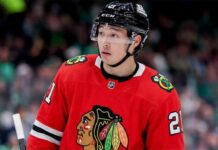 A close-up photograph of hockey player Jason Robertson wearing a red Chicago Blackhawks home jersey and sleeve number 21, looking off to the side, illustrating a hypothetical NHL trade scenario.