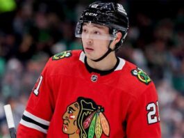 A close-up photograph of hockey player Jason Robertson wearing a red Chicago Blackhawks home jersey and sleeve number 21, looking off to the side, illustrating a hypothetical NHL trade scenario.